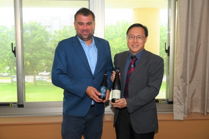 Vice President Dr. Chou and Dr. Petr Valášek present gifts to aach Other.