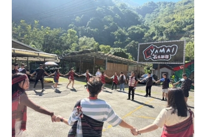 Students hold hands and perform the welcoming dance.