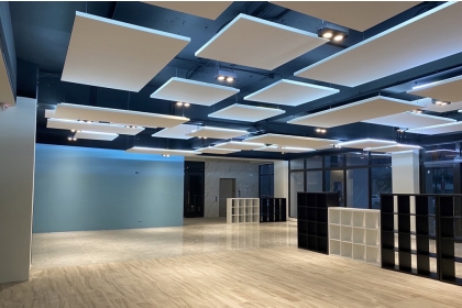 The floating acoustic ceiling in the first-floor lobby is designed for sound absorption and insulation.